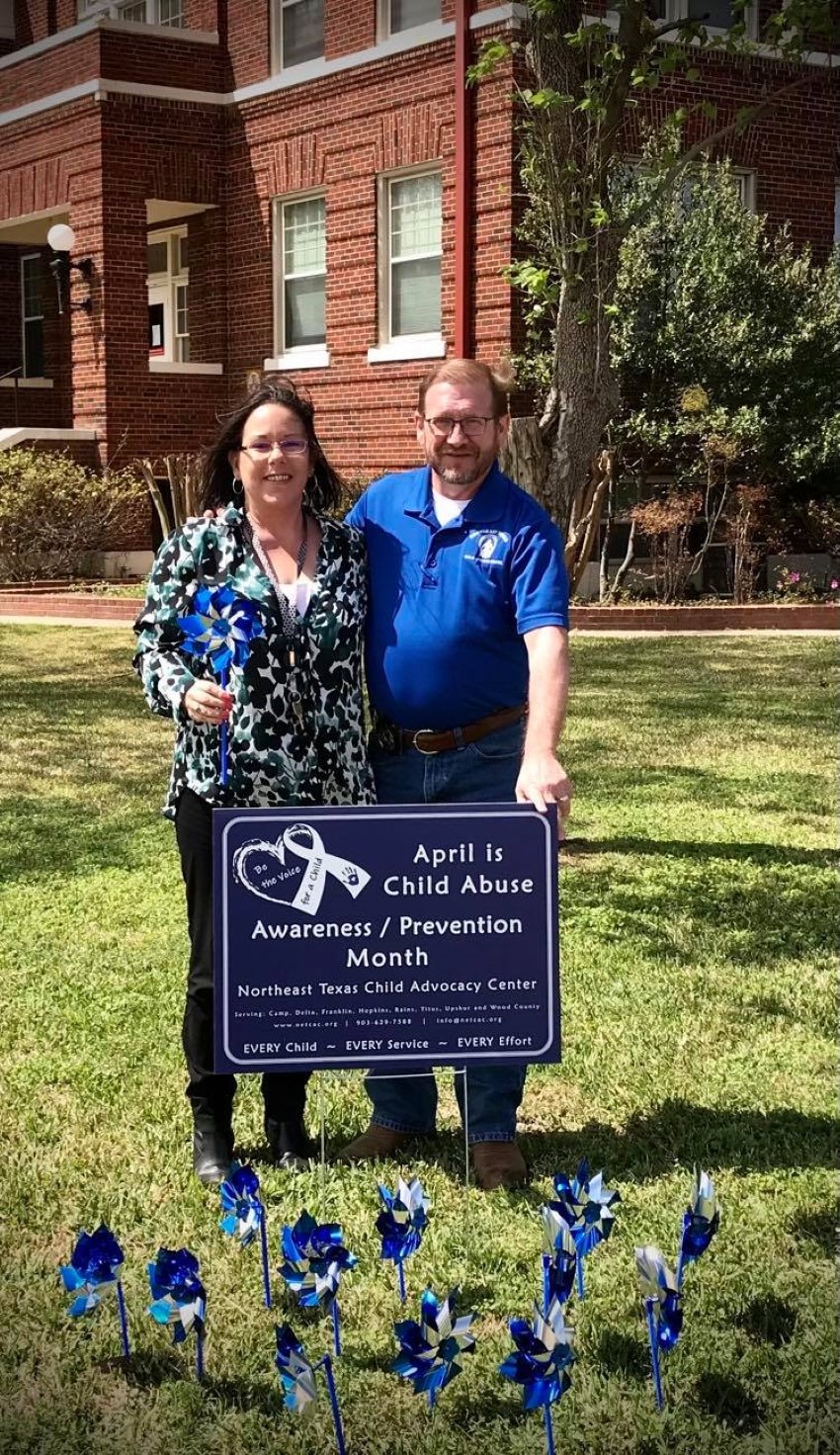 Pinwheels are planted each year at the Wood County courthouse to represent a child victim of abuse or neglect that is served. As the pinwheels sparkle and spin, know that their playful spirit is being renewed because of the essential services they are receiving from community members and organizations. Shown are Kiki Bettis, victims coordinator for Wood County DA’s office, and Freddy Fitzgerald of the Northeast Texas Child Advocacy Center. (Courtesy photo)